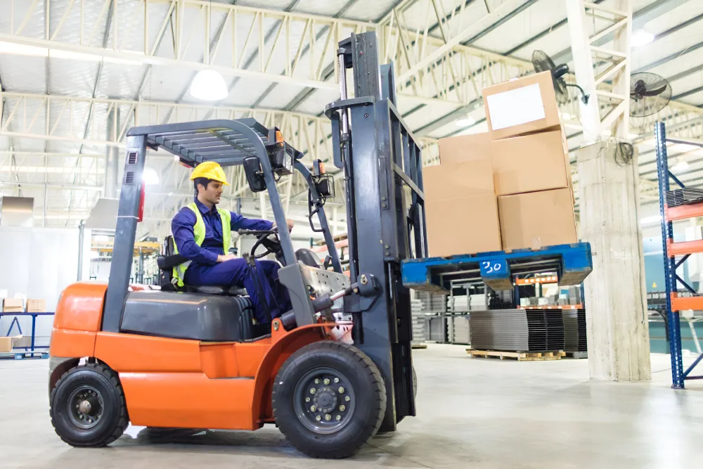 Warehouse worker operating a forklift